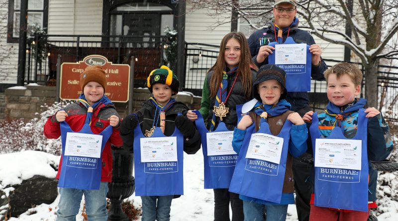 Some 1st Carp Scouts pose with grocery bags.