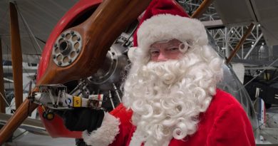 Santa holds an airplane.