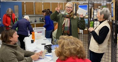 People pose at an art show.