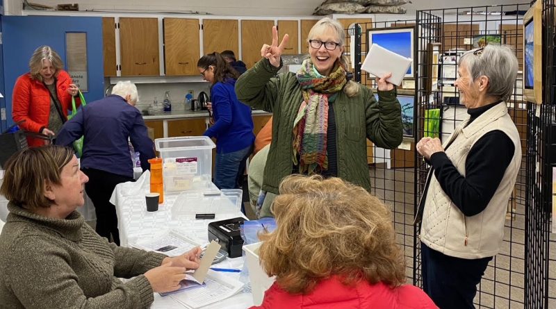 People pose at an art show.