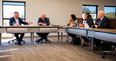 A group of people hold a meeting