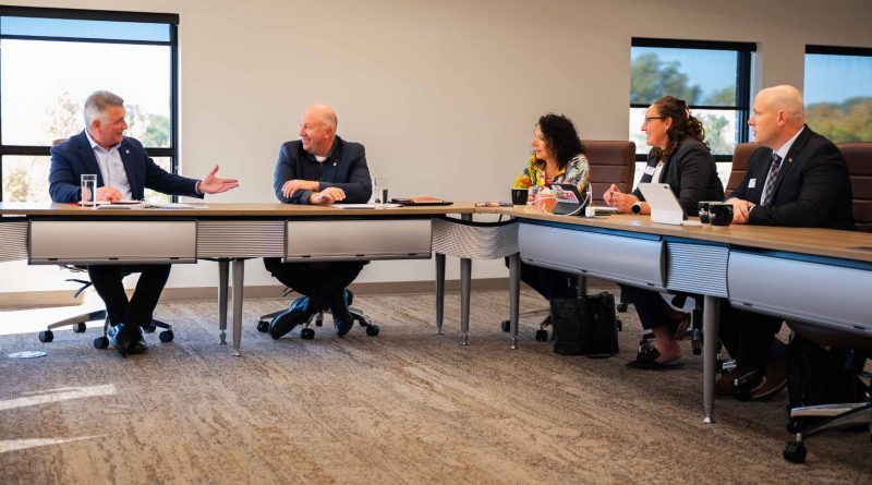 A group of people hold a meeting