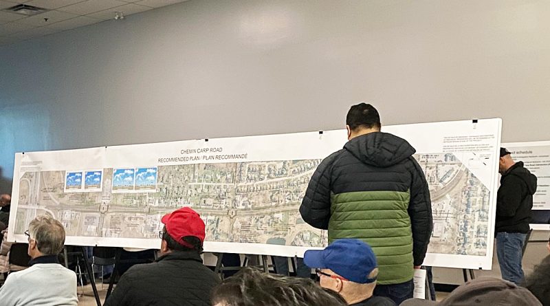 A person looks at a photo of Carp Road.