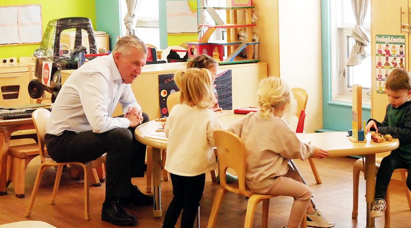 A man talks with kids.