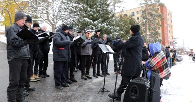 A chorus performs outside.