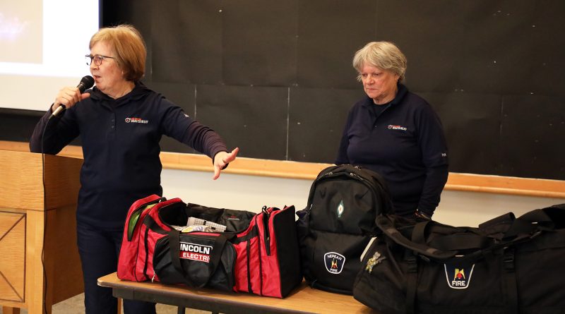 Two people share what is in their bag.