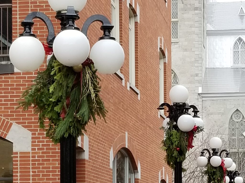 Lampposts with wreaths on them.