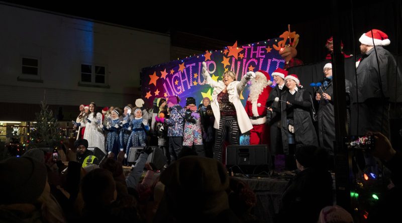 A photo of people celebrating on a stage.
