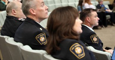 Four firefighters watch a presentation.