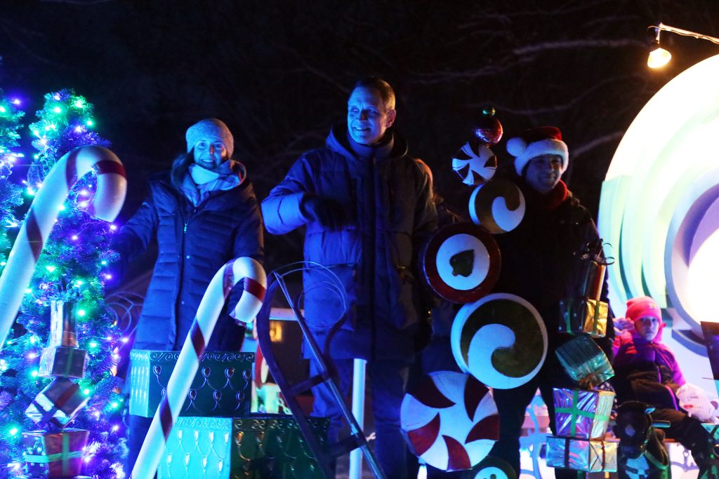 People wave from a float.