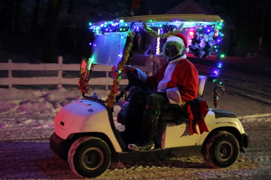 The Grinch drives a golf cart.