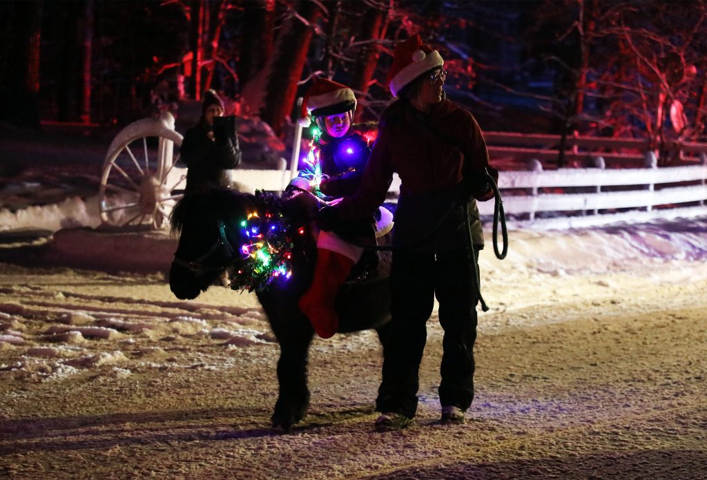 A young one rides a pony.