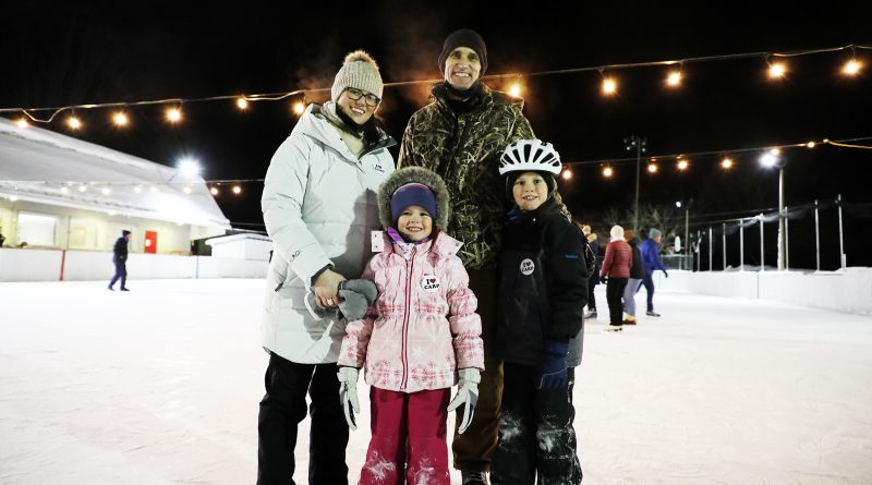 A photo of people on an outdoor rink.