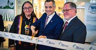 Dunrobin WI big part of Cultivating Community archives exhibit Three people cut a ribbon.