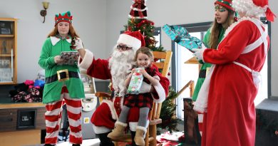 A photo of Santa handing out presents.