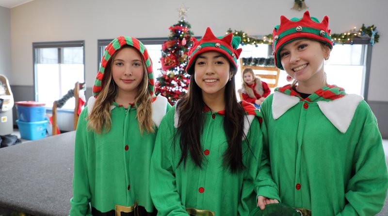 Three elves pose for a photo.