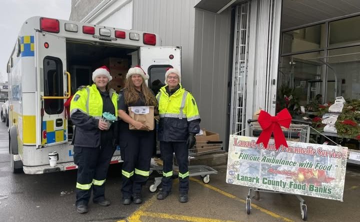 Lanark paramedics pose beside an ambulance.