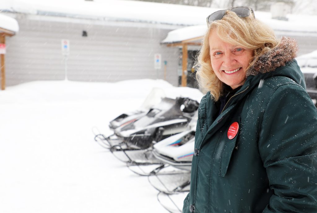 A woman poses in the snow.