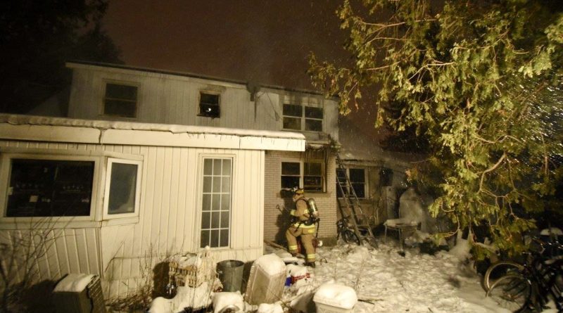 A firefighter searches a house.