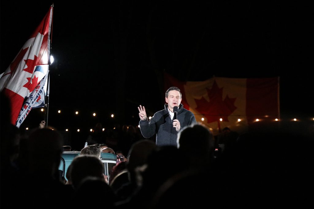 A man speaks to thousands at a rally.