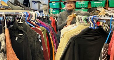 A woman poses in a boutique.
