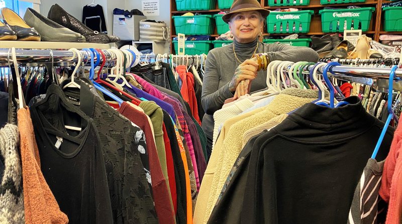 A woman poses in a boutique.