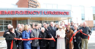 A group of people cut a ribbon.