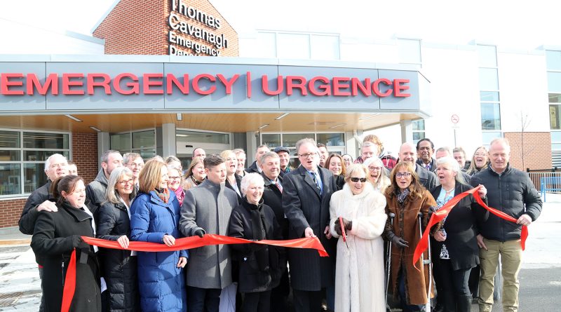 A group of people cut a ribbon.