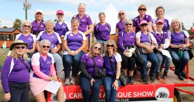 A group poses on a wagon.