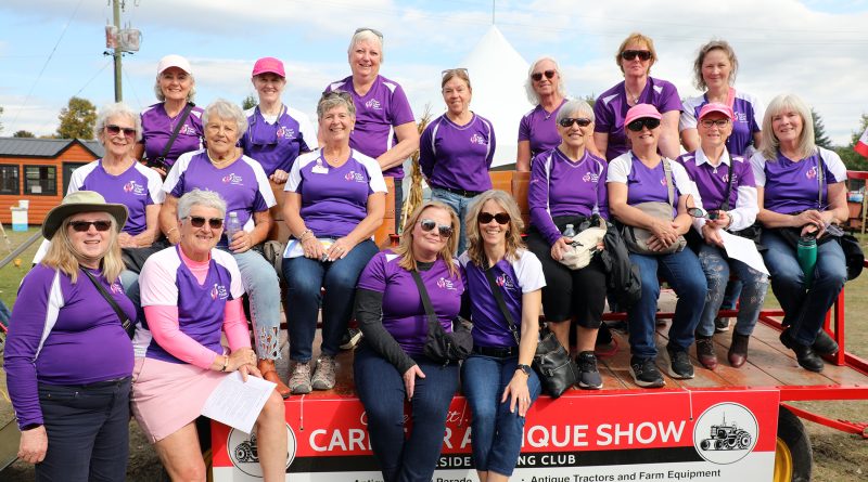 A group poses on a wagon.
