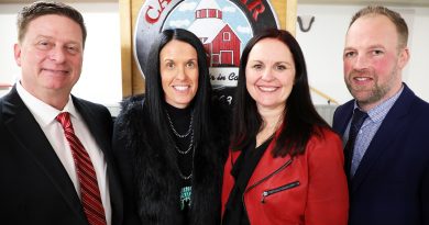 Four people pose for a photo.