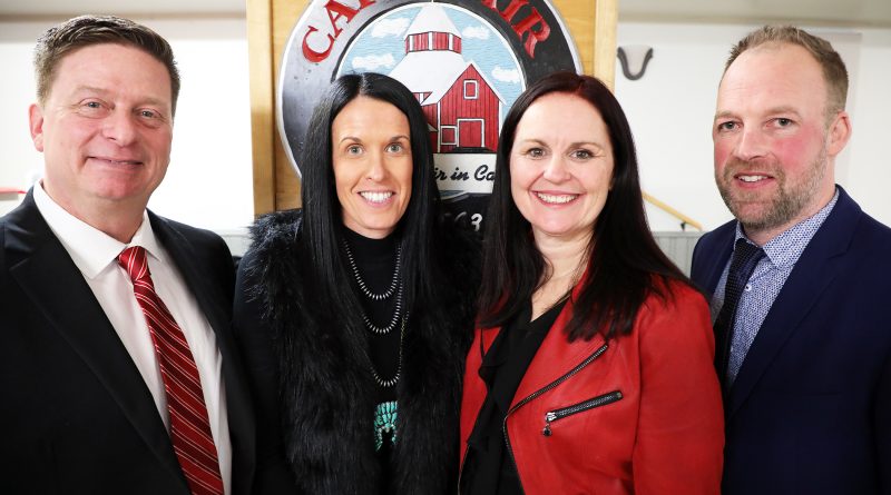 Four people pose for a photo.