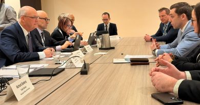 Kelly focuses on infrastructure matching growth at ROMA People talk at a table.