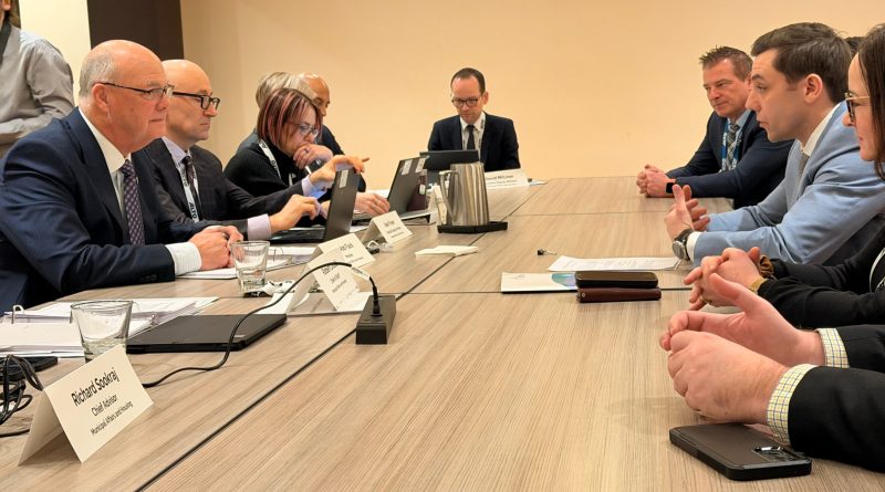 People talk at a table.