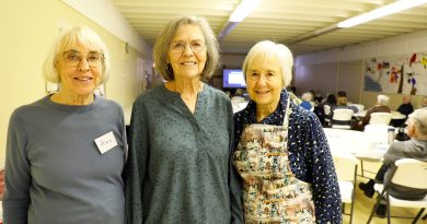 Three people pose for a photo.