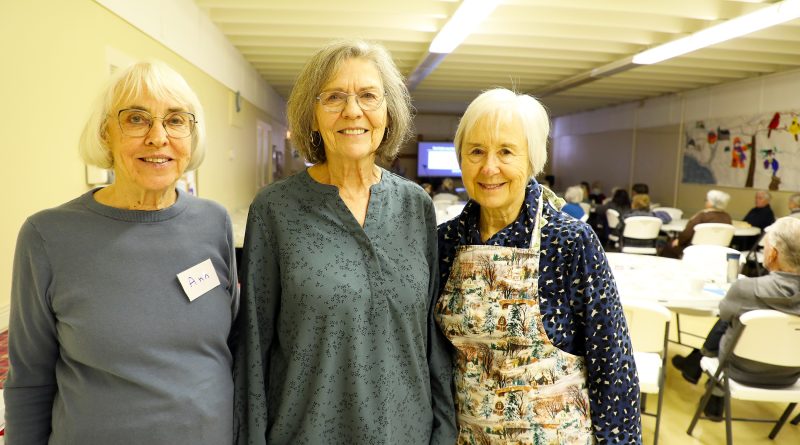 Three people pose for a photo.