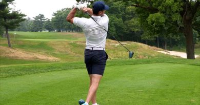 A photo of a golfer swinging.