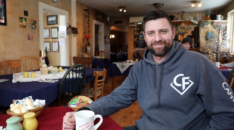 A man sits in a coffee shop.