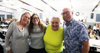 Four people pose for a photo.