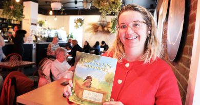 A photo of a woman holding a book.