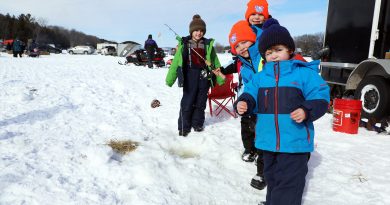 Some young kids ice fish.