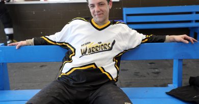 A photo of a hockey player taking a break.