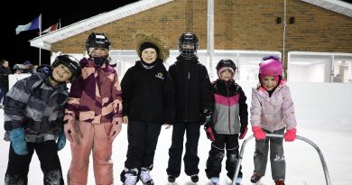 A group of skaters pose for a photo.