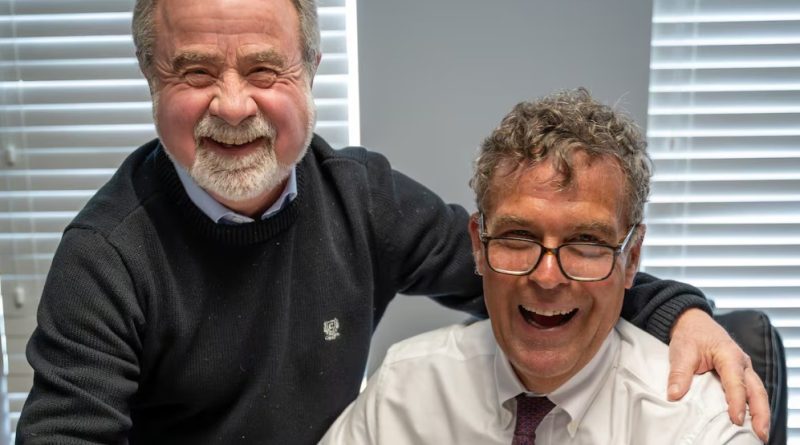 Two people pose for a photo.