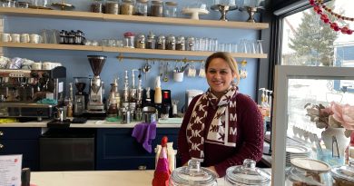 A woman poses in a cafe.