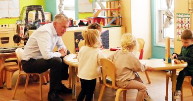 A politician meets with kids.