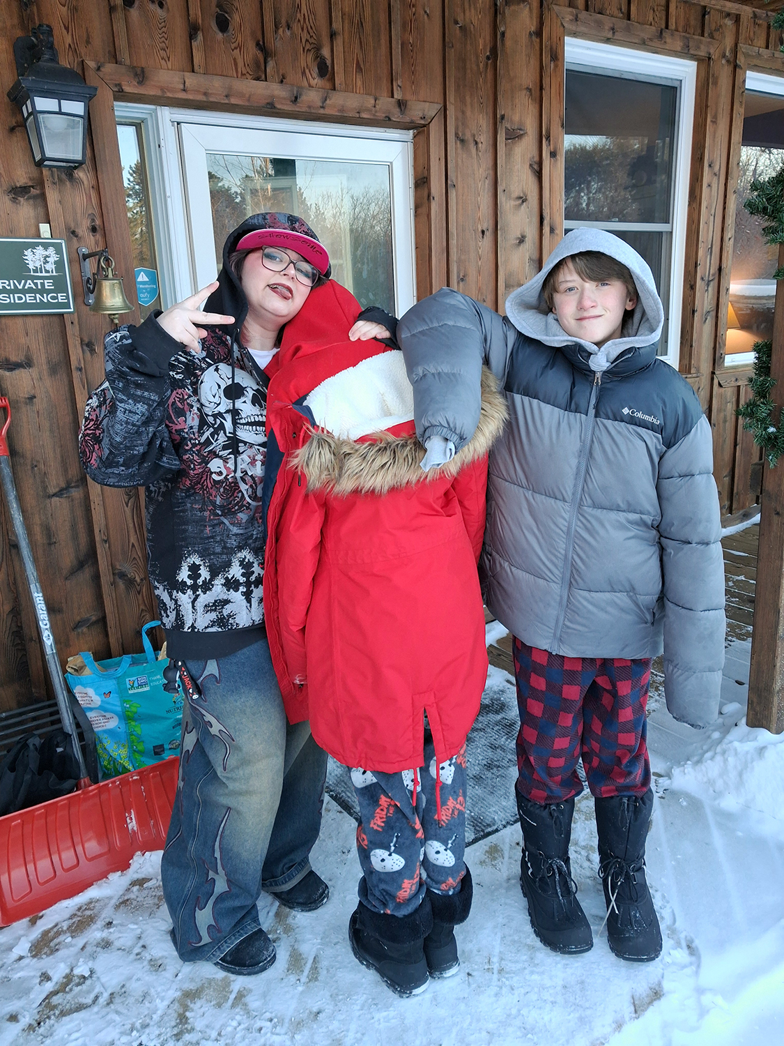Three kids pose for a photo.