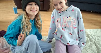 Two girls pose for a photo.