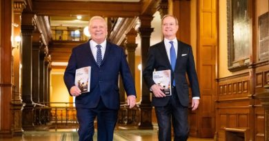 Provincial budget has no new news for Ottawa Two people walk down a hall.