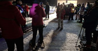 A group of snowshoers get ready for a hike.